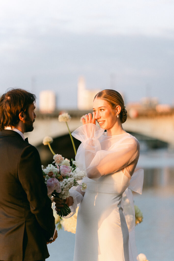 Bride crying during the exchange of vows in front of the Eiffel Tower