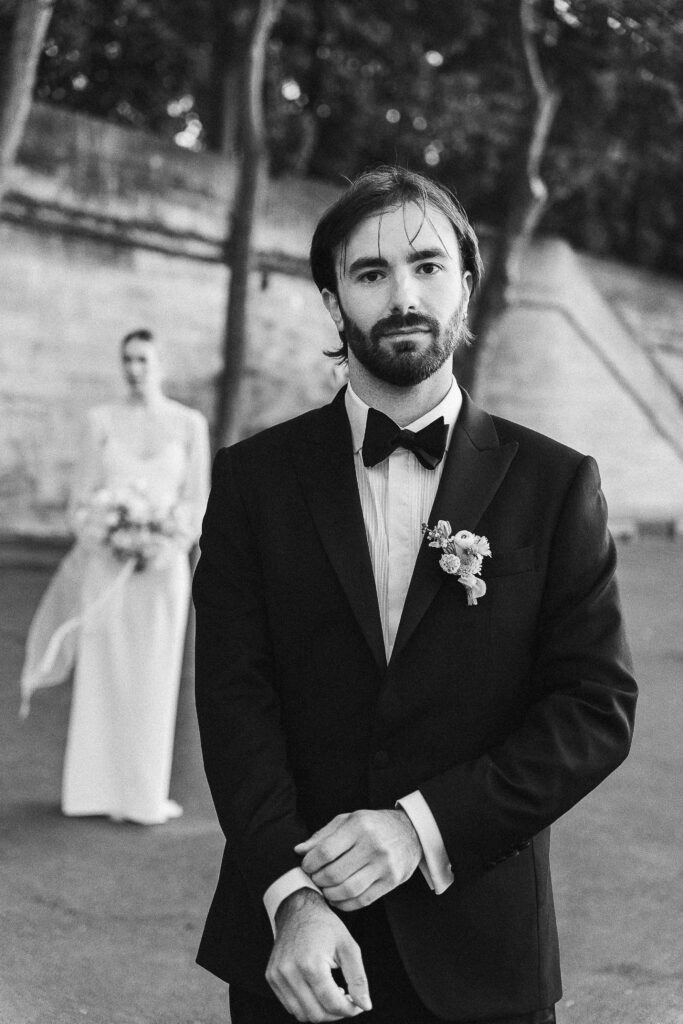 
Groom patiently waiting for the bride in front of the Eiffel Tower
