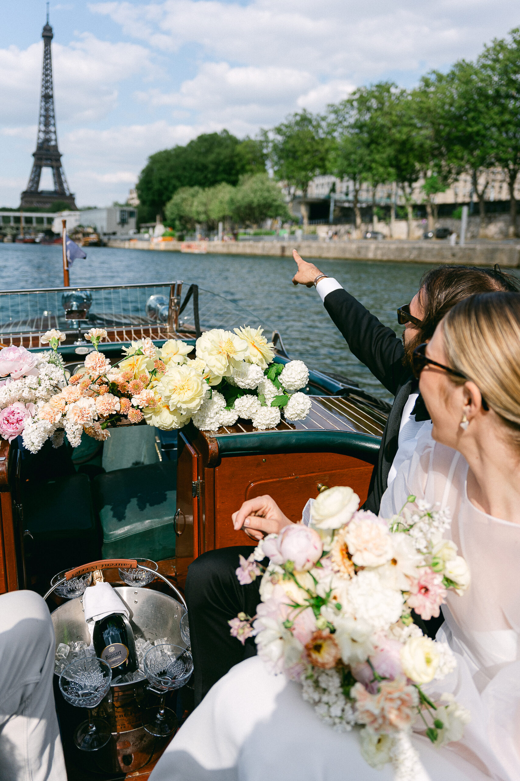 the bride and groom on a French Riviera-style boat on the Seine in Paris