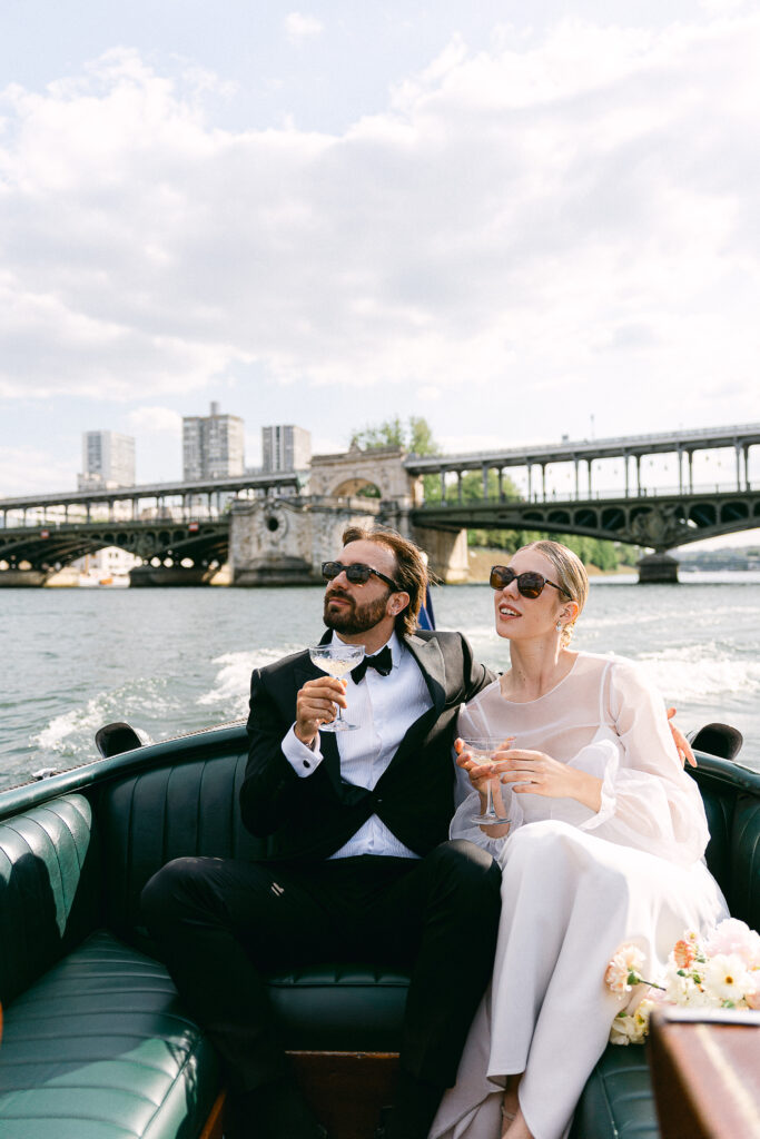 the bride and groom on a French Riviera-style boat on the Seine river in Paris
