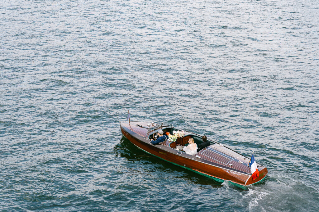 the bride and groom on a French Riviera-style boat on the Seine river in Paris