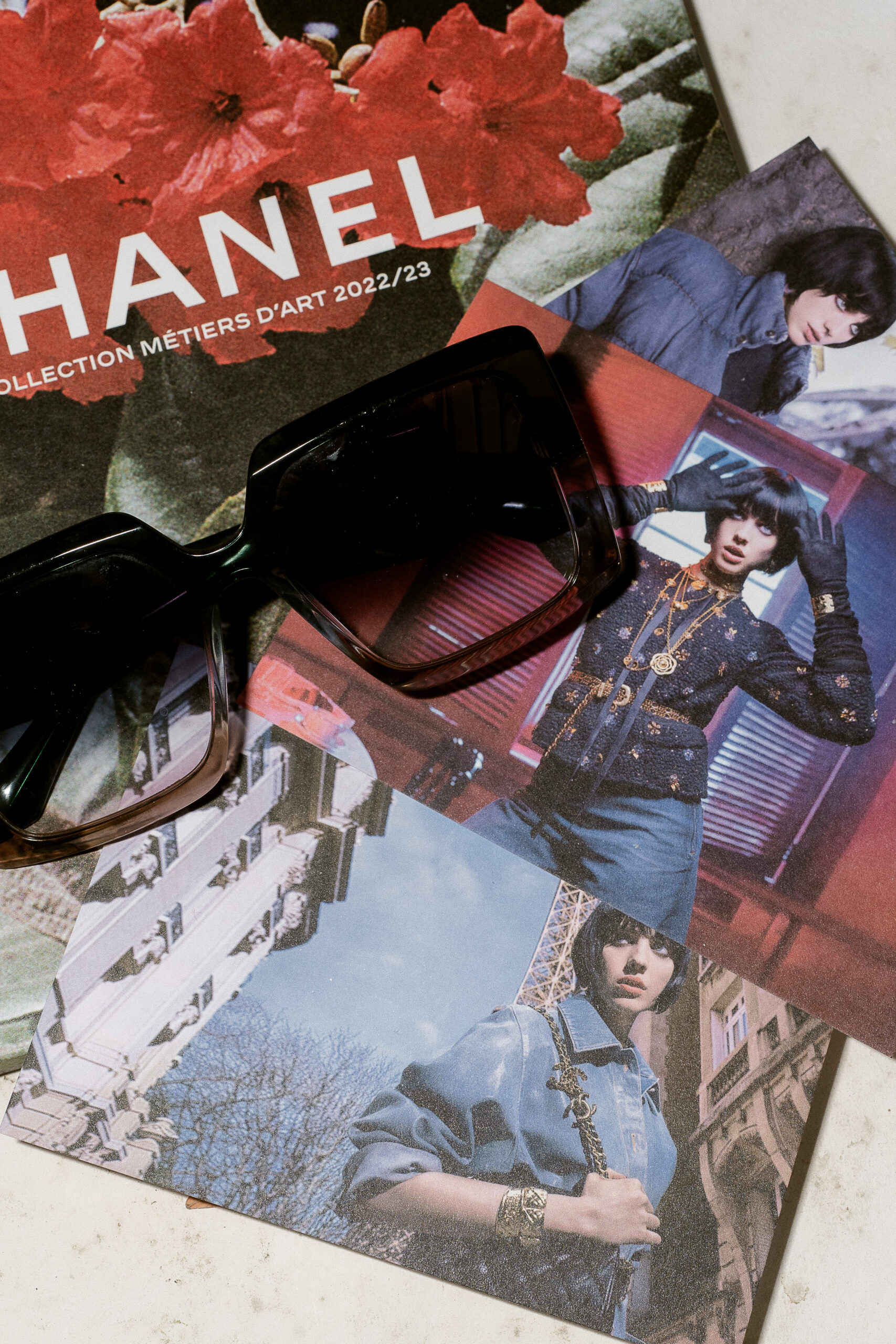 Editorial style photo featuring a Chanel magazine and refined fashion elements
