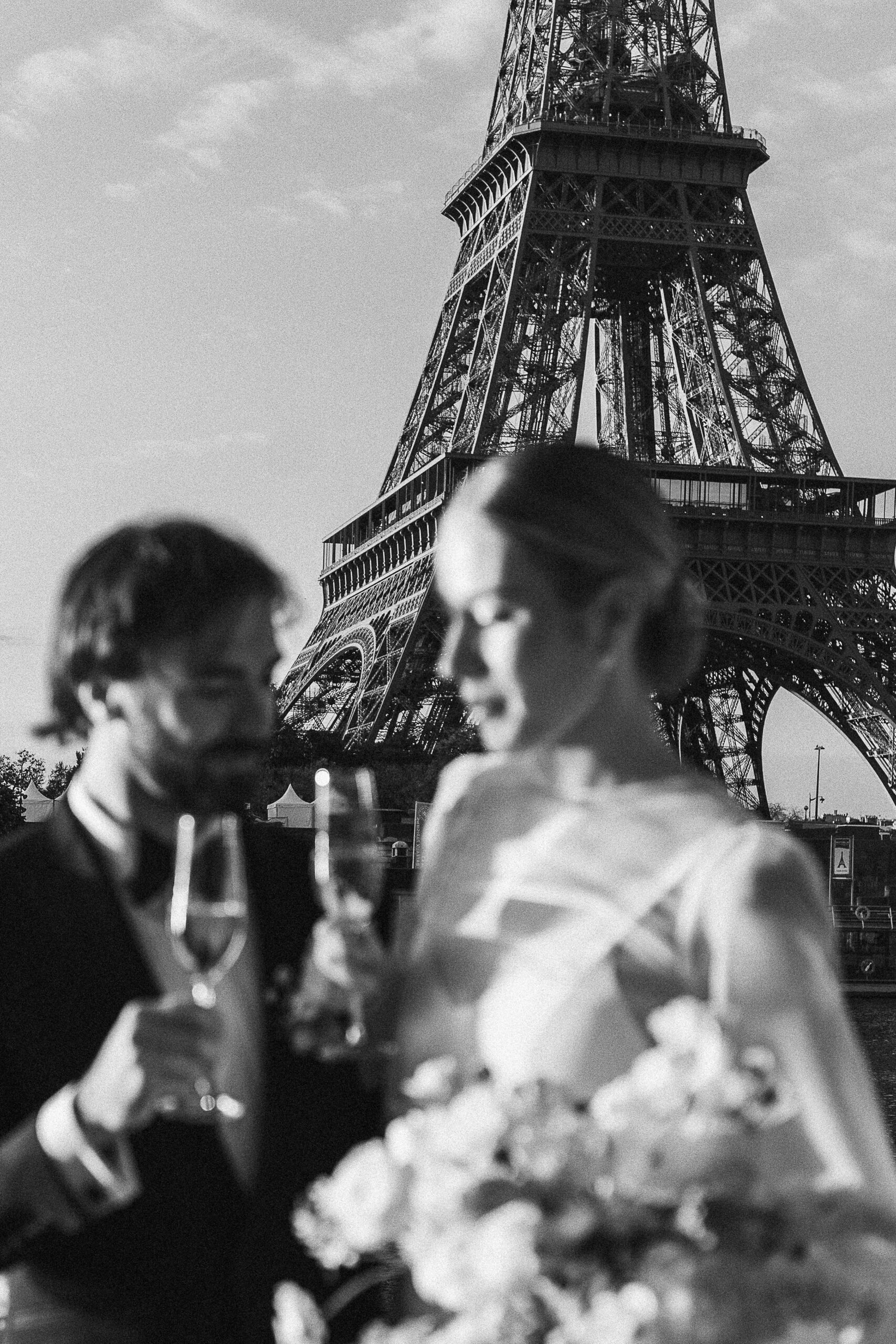 British couple toasting with champagne in front of the Eiffel Tower, Julie Chef Photography